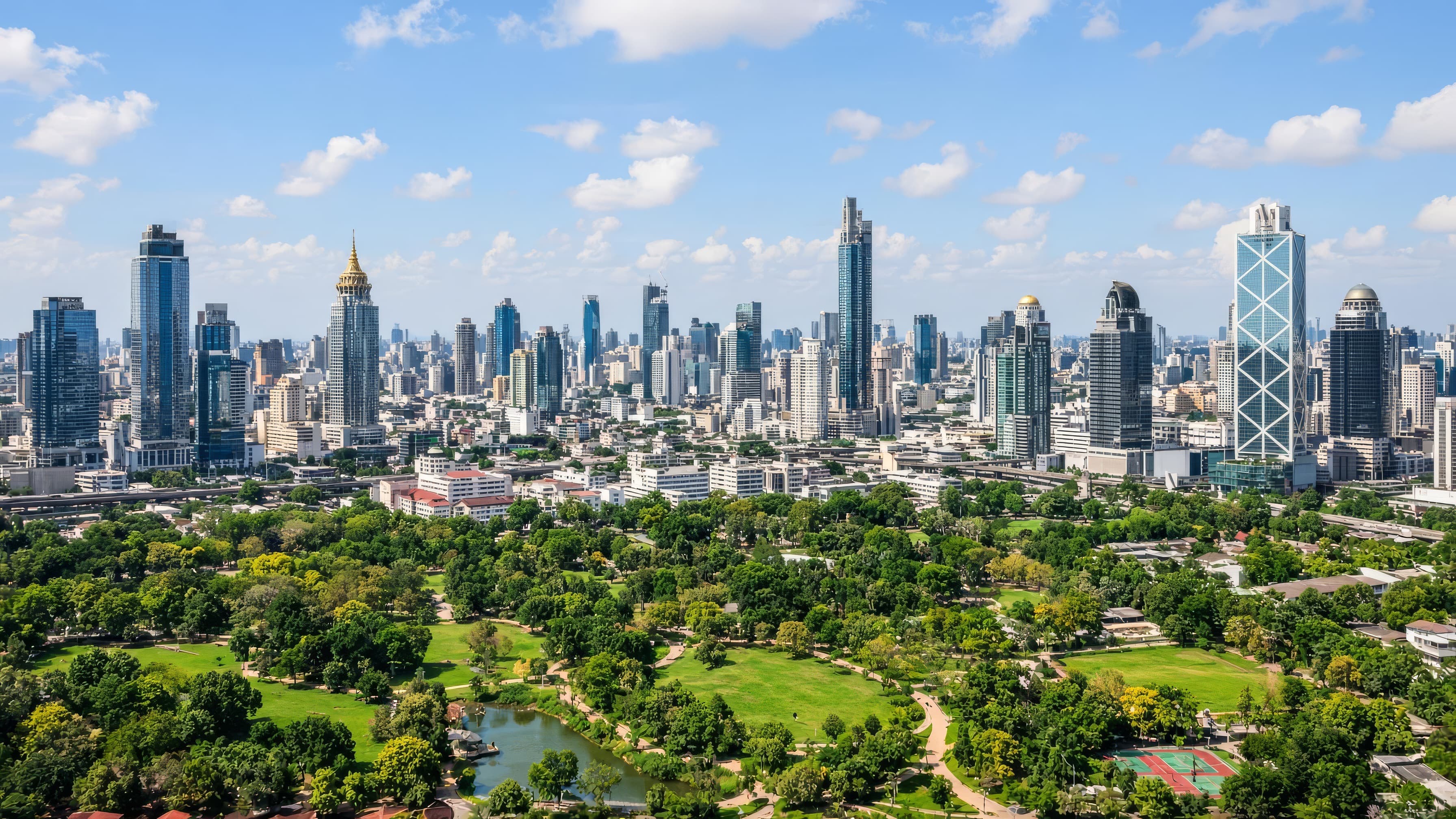 Bangkok skyline above a green city park on a clear day