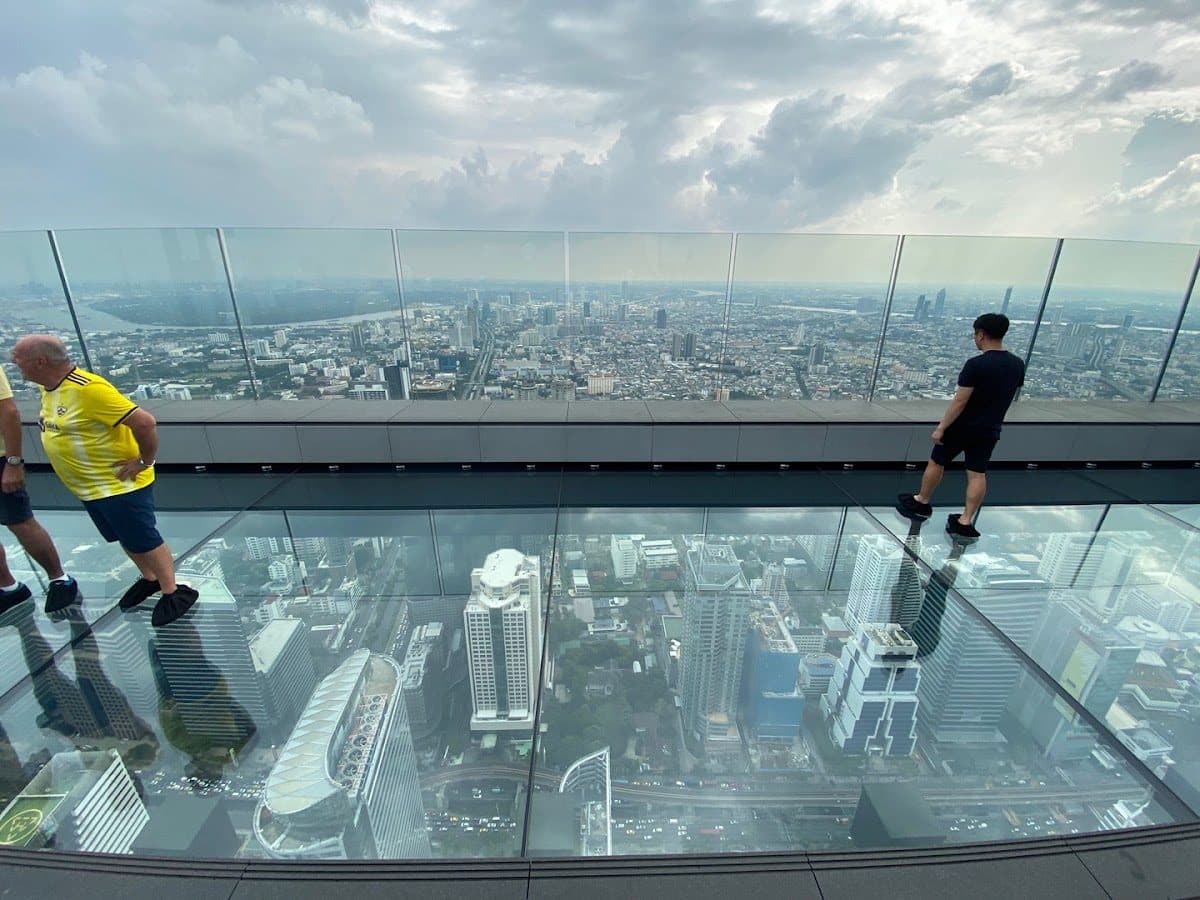Visitors on the glass-floor SkyWalk of King Power Mahanakhon, the pixelated tower near Arawana Hoft Hostel