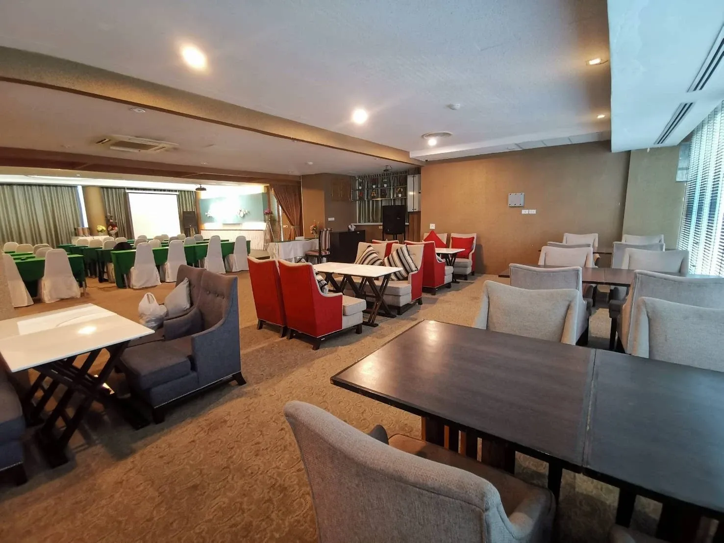 Restaurant seating with dining tables and armchairs at Arawana Regency Ratchada